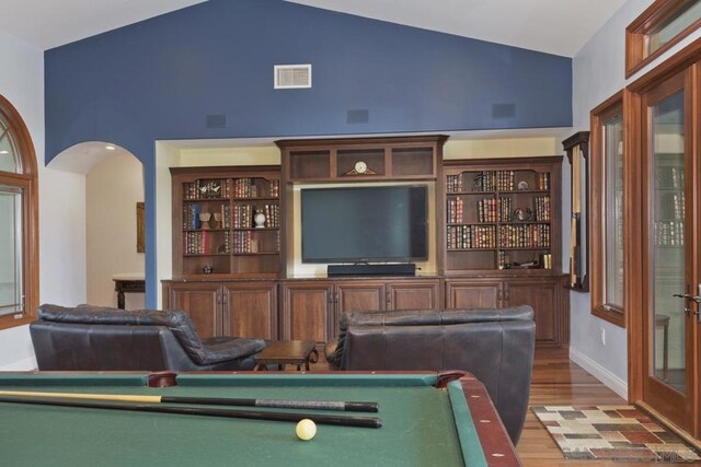 rec room with high vaulted ceiling, bar, wood-type flooring, and pool table