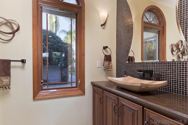 bathroom featuring decorative backsplash and vanity