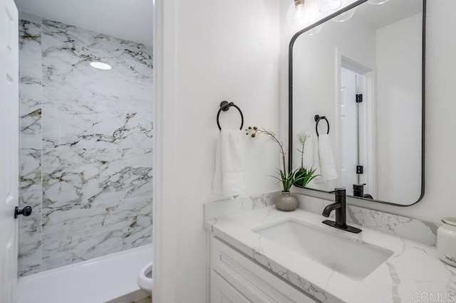 bathroom featuring walk in shower and vanity