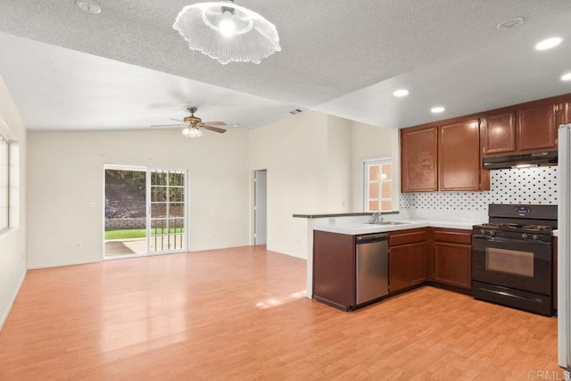 kitchen featuring dishwasher, light hardwood / wood-style floors, sink, black range with gas cooktop, and a textured ceiling