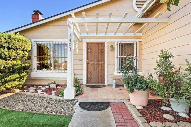 doorway to property with a pergola