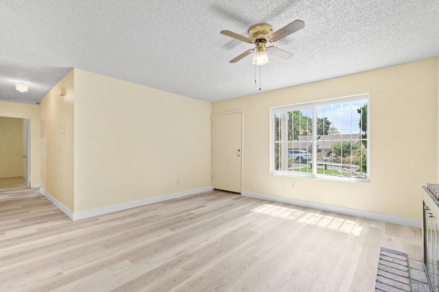 1403 Goff Ct, San Diego, CA 92114 - unfurnished living room featuring a textured ceiling, ceiling fan, light wood-type flooring, and baseboards