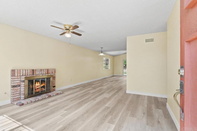 1403 Goff Ct, San Diego, CA 92114 - unfurnished living room with a ceiling fan, wood finished floors, a brick fireplace, baseboards, and a textured ceiling