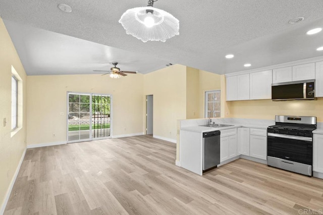 1403 Goff Ct, San Diego, CA 92114 - kitchen with stainless steel appliances, a sink, light wood-type flooring, white cabinetry, and a textured ceiling