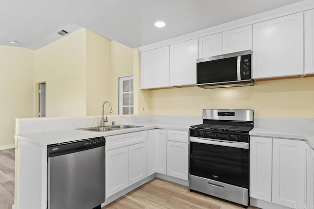 1403 Goff Ct, San Diego, CA 92114 - kitchen with stainless steel appliances, a sink, a peninsula, light wood-style flooring, and white cabinetry
