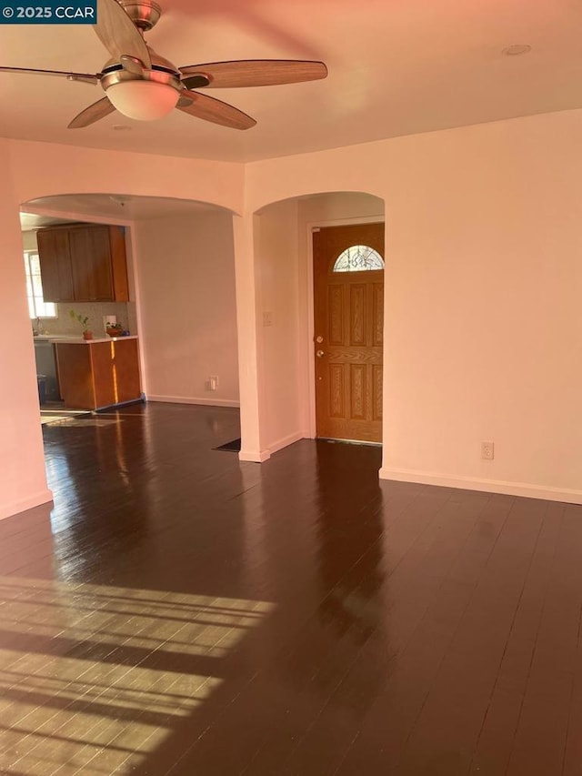 unfurnished room featuring ceiling fan and dark hardwood / wood-style flooring