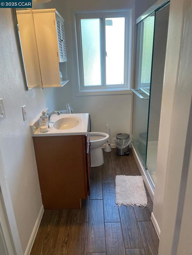 bathroom featuring a shower with door, wood-type flooring, toilet, and vanity