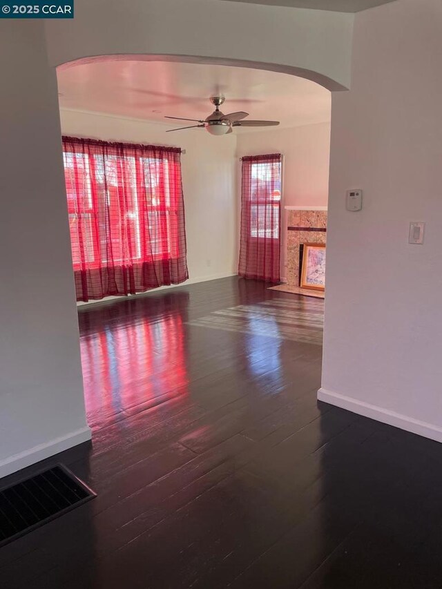 empty room featuring ceiling fan and hardwood / wood-style floors