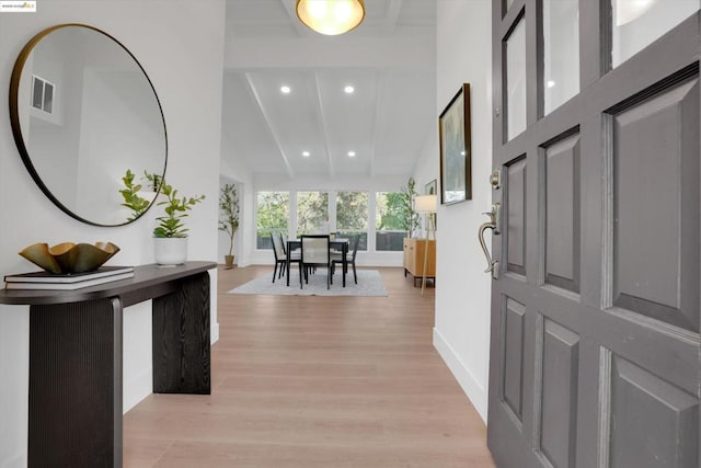 foyer entrance featuring high vaulted ceiling and light hardwood / wood-style flooring