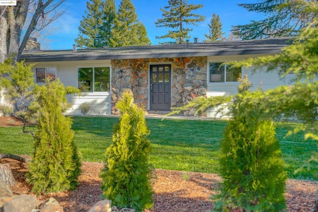 doorway to property with a yard