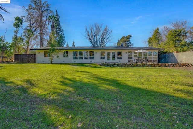 rear view of property with a yard