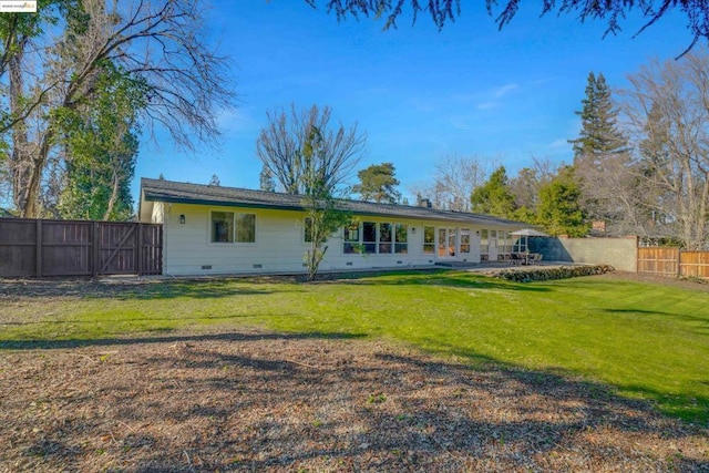 rear view of house featuring a patio area and a yard