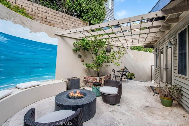 view of patio / terrace with a fire pit and a pergola