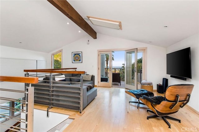 living room featuring vaulted ceiling with beams, french doors, and light wood-type flooring