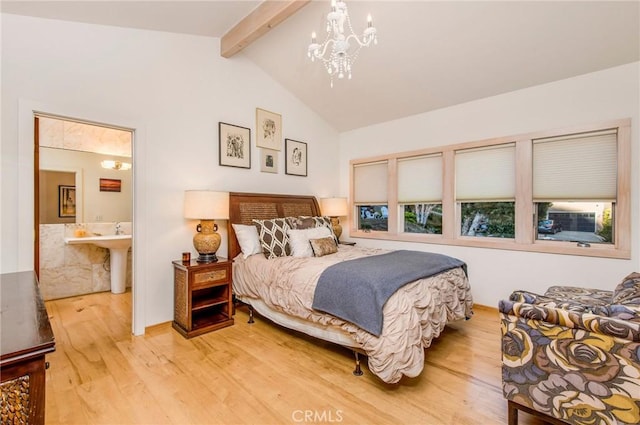 bedroom with a notable chandelier, connected bathroom, hardwood / wood-style floors, and lofted ceiling with beams