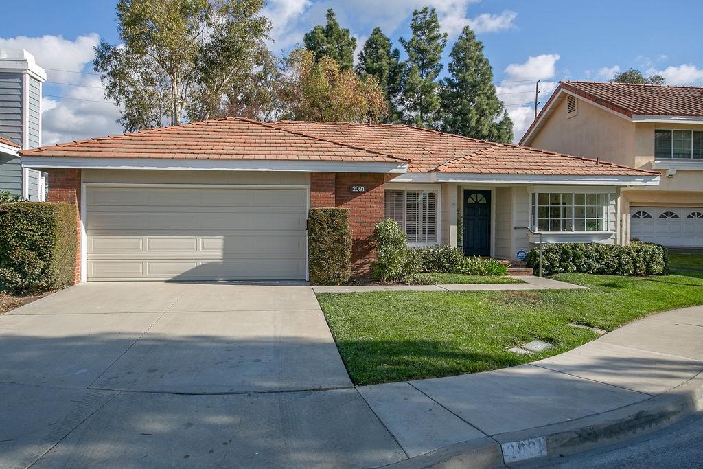 view of front of property with a garage and a front yard