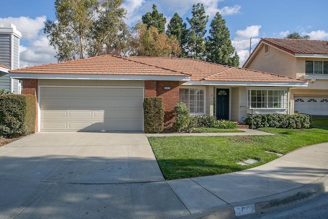 view of front of property with a garage and a front yard