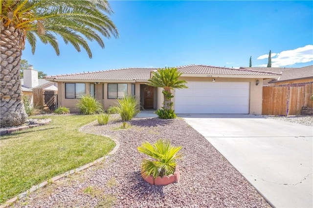 ranch-style home featuring a garage and a front lawn