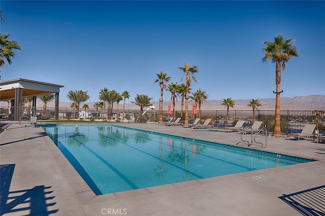 view of swimming pool featuring a mountain view and a patio