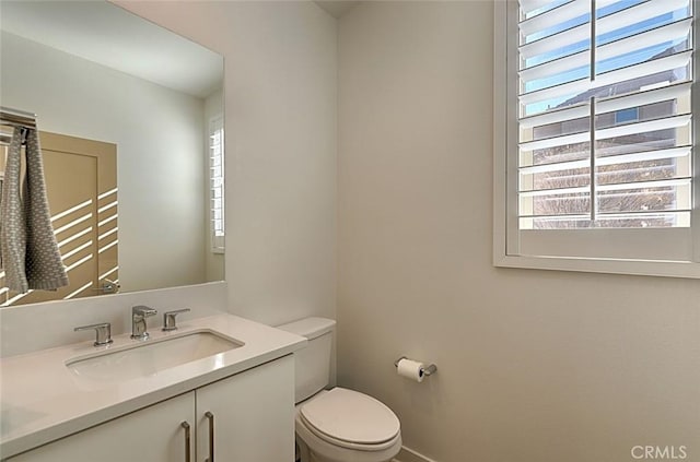 bathroom with toilet and vanity