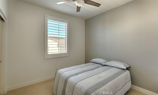 bedroom featuring light carpet and ceiling fan