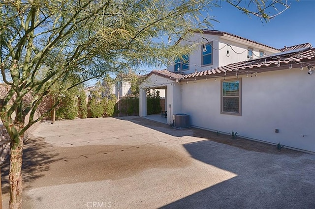 view of home's exterior with central AC unit and a patio area