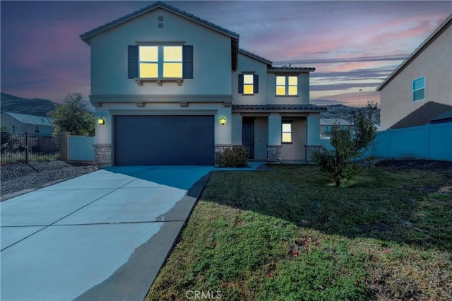 view of property featuring a garage and a yard