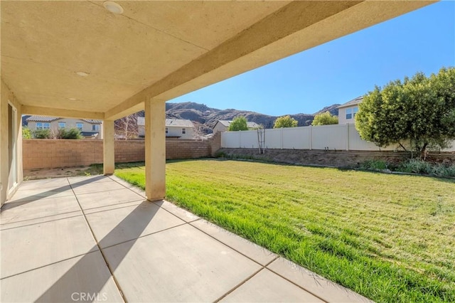 view of yard with a mountain view and a patio