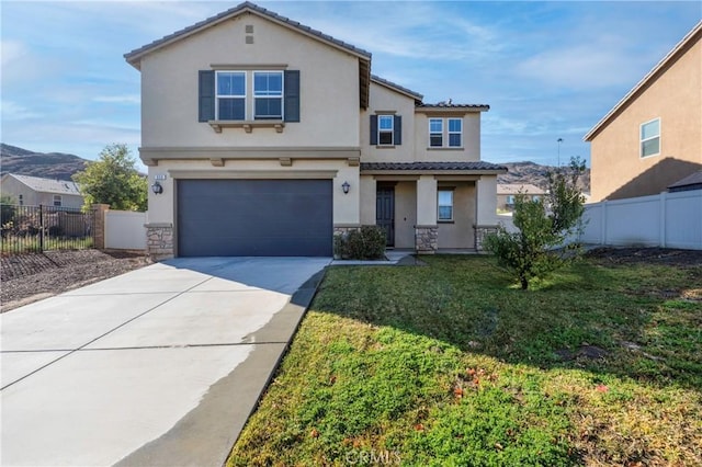 view of front of house with a garage and a front yard