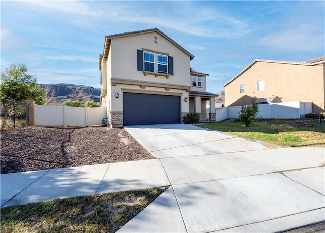 view of front of house with a mountain view and a garage