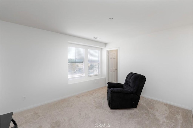 sitting room featuring light carpet