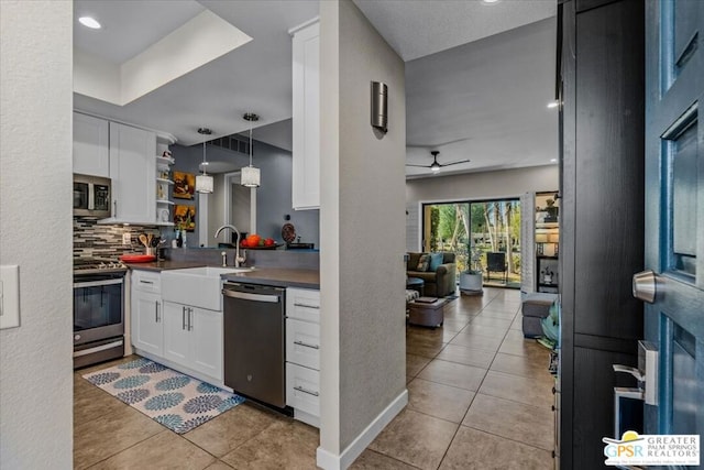 kitchen featuring ceiling fan, sink, white cabinetry, and appliances with stainless steel finishes