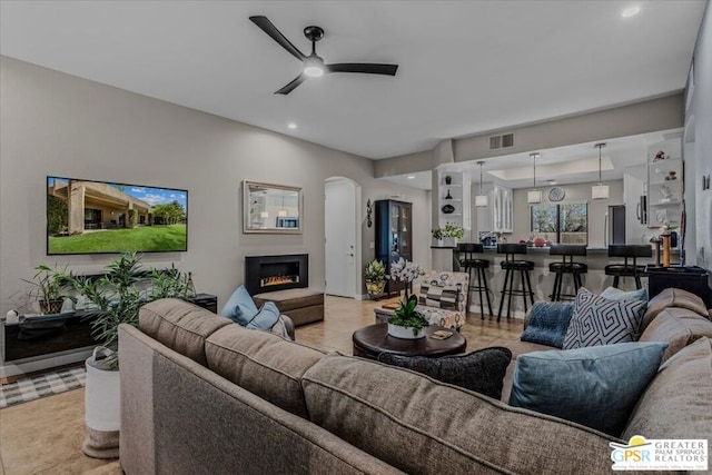 living room with ceiling fan and light tile patterned floors