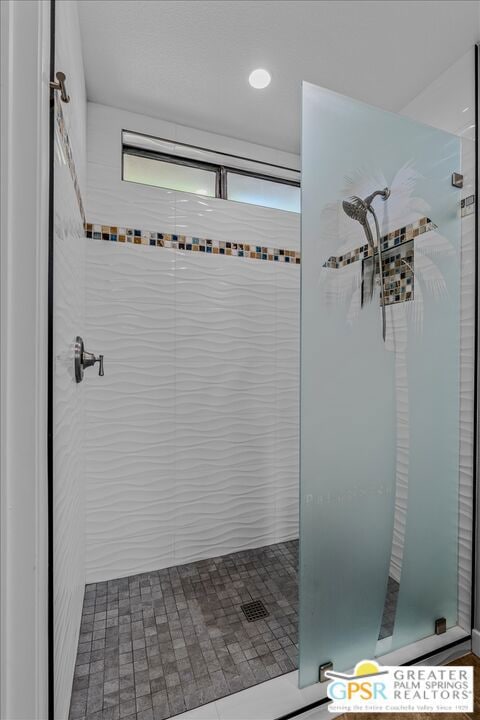 bathroom with a tile shower