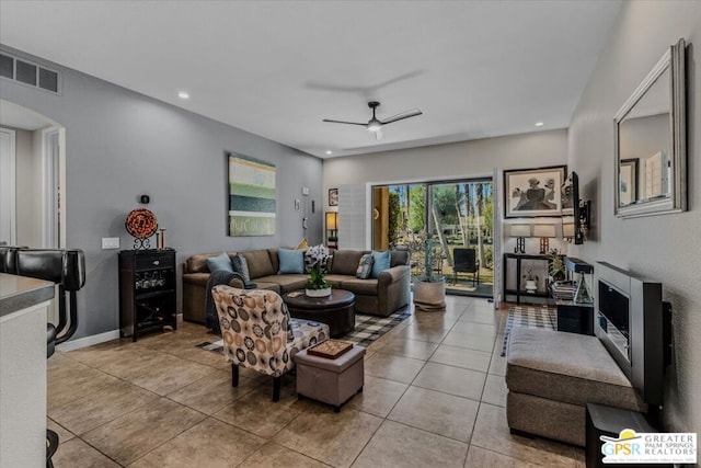 tiled living room with ceiling fan