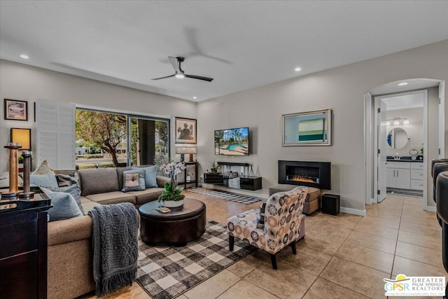 living room featuring ceiling fan and light tile patterned floors