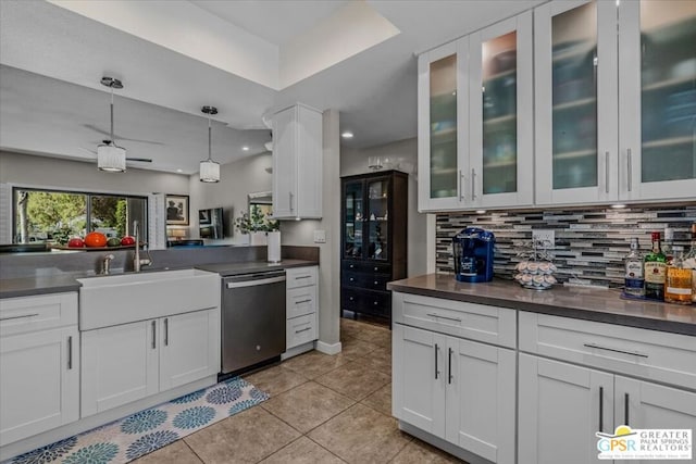 kitchen with backsplash, dishwasher, hanging light fixtures, white cabinets, and sink