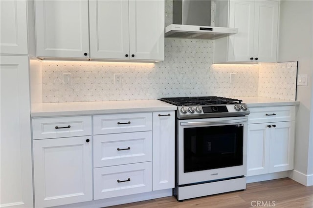 kitchen with white cabinets, decorative backsplash, wall chimney exhaust hood, and stainless steel gas range