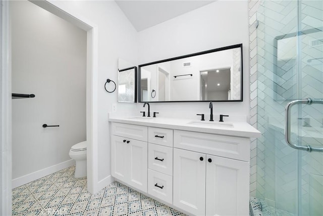 bathroom featuring toilet, an enclosed shower, and vanity