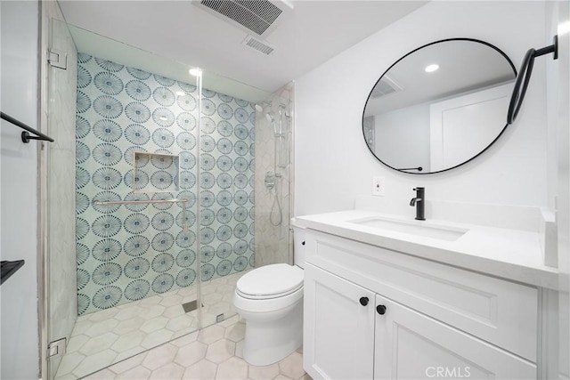 bathroom with toilet, vanity, an enclosed shower, and tile patterned floors