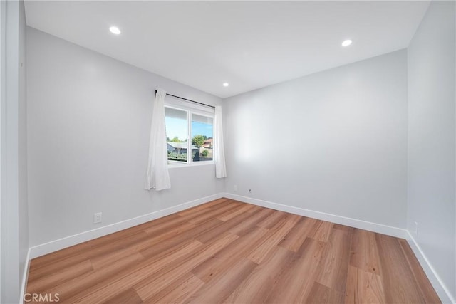 unfurnished room with light hardwood / wood-style floors