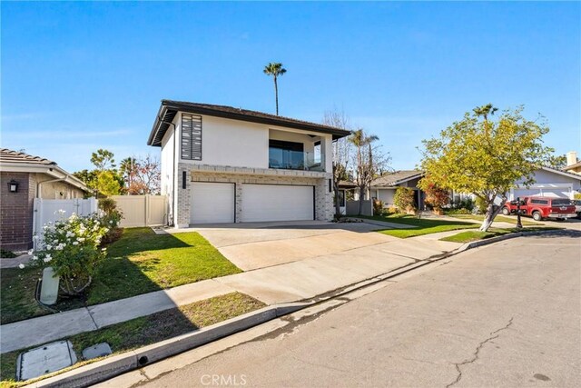 view of front of home featuring a front lawn and a garage