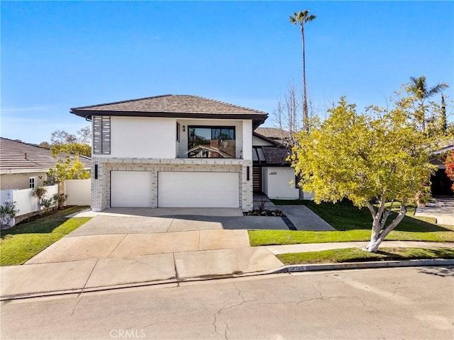 view of front of property with a garage and a front lawn