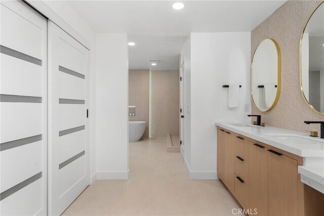 bathroom featuring vanity and a bathtub