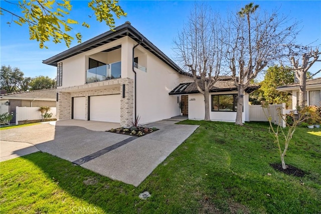 view of front of house featuring a garage and a front lawn