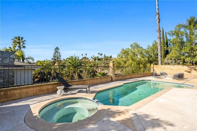 view of pool with an in ground hot tub and a patio area