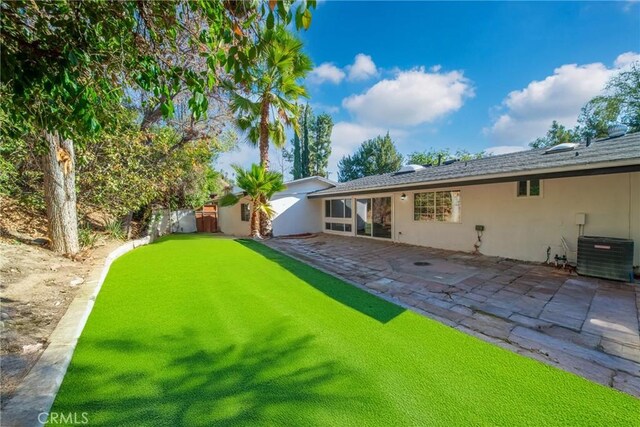 view of yard with a patio area and central air condition unit