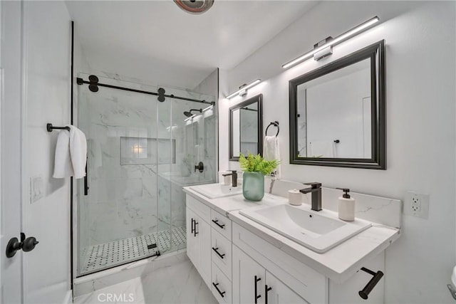 bathroom featuring a shower with shower door and vanity