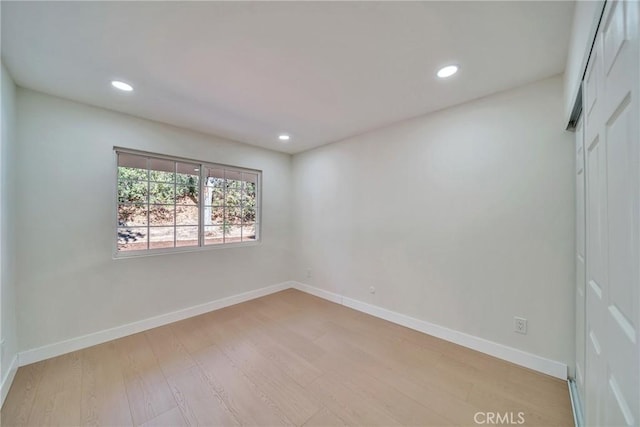 unfurnished room with light wood-type flooring