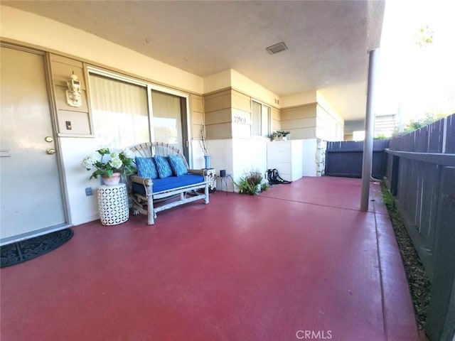 view of patio featuring fence